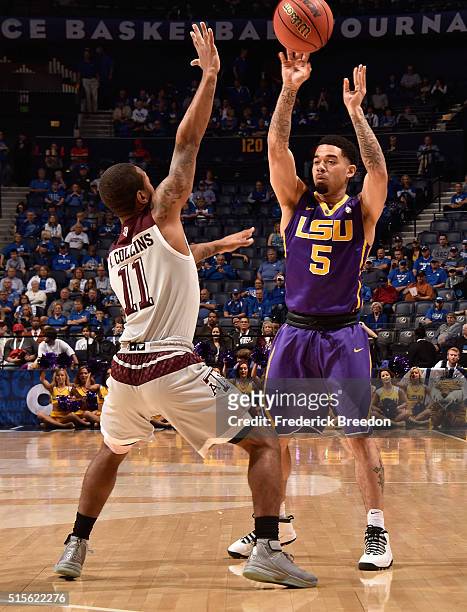 Josh Gray of the LSU Tigers plays against Anthony Collins of the Texas A&M Aggies in an SEC Basketball Tournament Semifinals game at Bridgestone...