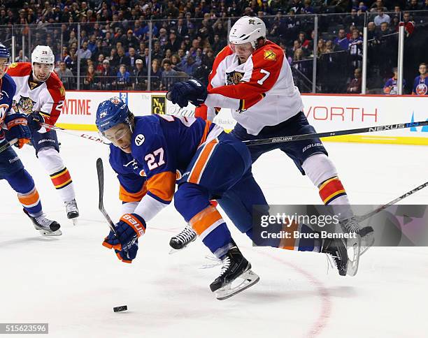 Anders Lee of the New York Islanders is checked by Dmitry Kulikov of the Florida Panthers during the second period at the Barclays Center on March...