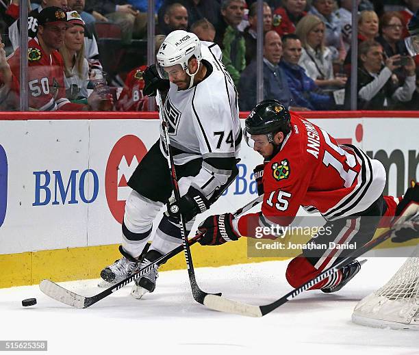 Dwight King of the Los Angeles Kings and Artem Anisimov of the Chicago Blackhawks battle for the puck at the United Center on March 14, 2016 in...