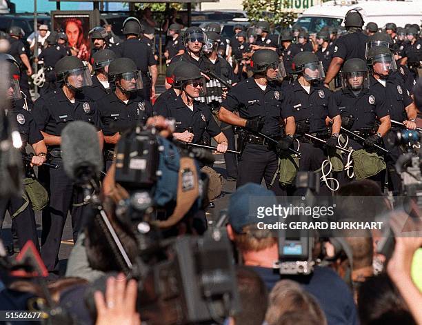 Los Angeles Police Department officers take over a street corner adjacent to the Staples Center, site of the 2000 Democratic National Convention,...