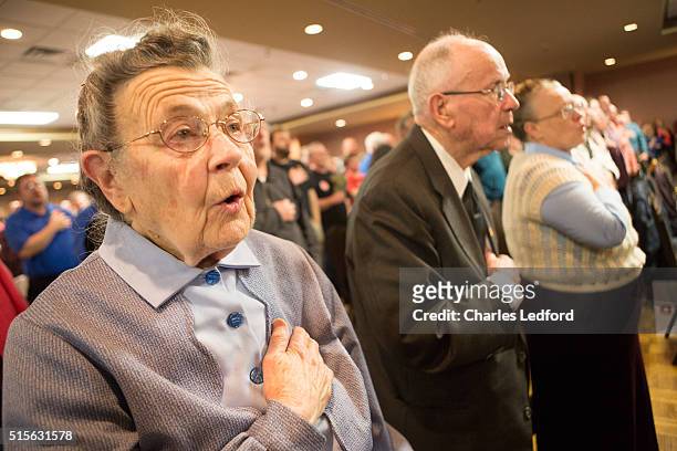 Ruth Douglas of Decatur, Illinois, recites the Pledge of Allegiance before U.S. Senator Ted Cruz speaks at a campaign rally for the candidate on...