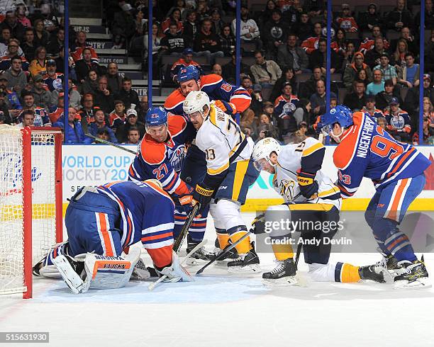 Colin Wilson and Craig Smith of the Nashville Predators battle in front of the net against Adam Clendening, Nikita Nikitin, Ryan Nugent-Hopkins and...
