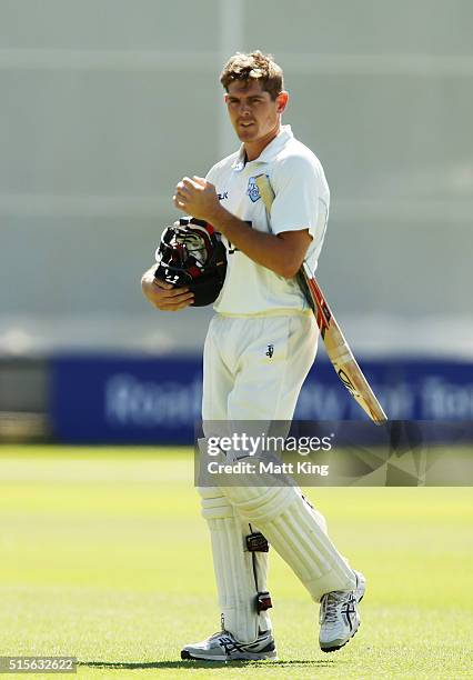 Daniel Hughes of the Blues walks from the field after being dismissed by Chris Tremain of the Bushrangers during day one of the Sheffield Shield...
