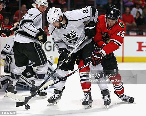 Drew Doughty of the Los Angeles Kings battles for the puck with Artem Anisimov of the Chicago Blackhawks at the United Center on March 14, 2016 in...