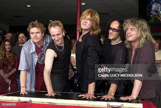 British heavy metal rock group 'Def Leppard' make their handprints to be put in the Rockwalk on the sidewalk in Hollywood, 05 September 2000. From...
