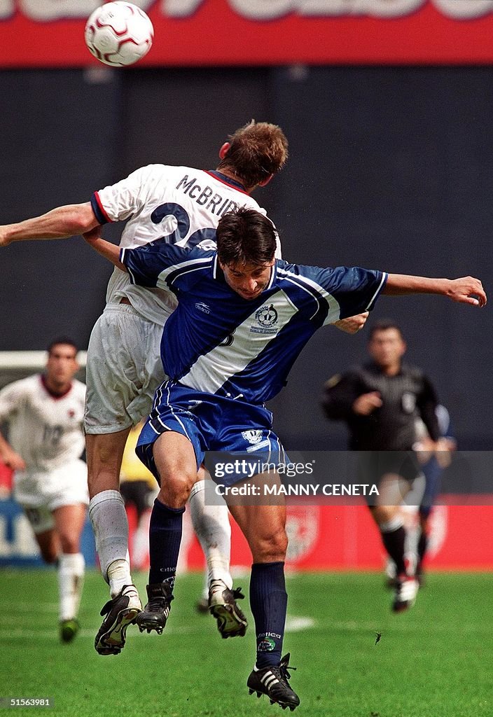 Guatemala's Erick Miranda battles a header against Brian McBride of