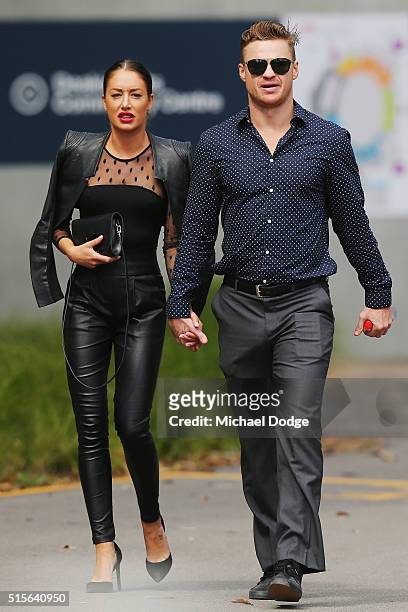 Former AFL player Colin Sylvia arrives with his partner during the memorial service for Paul Couch at Simonds Stadium on March 15, 2016 in Geelong,...