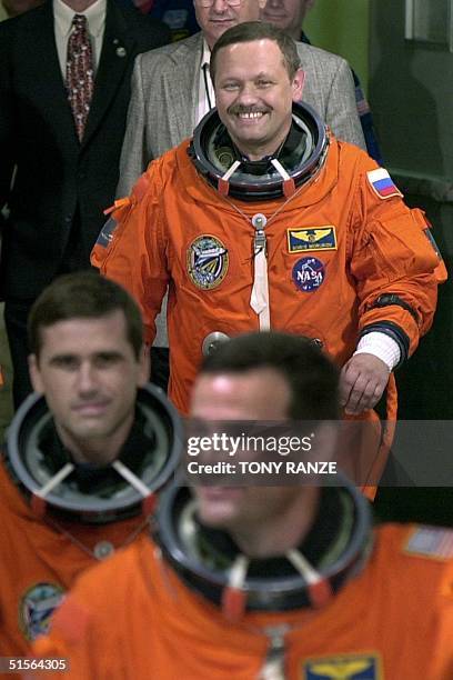 Space shuttle Atlantis Pilot Scott Altman is followed by Russian Mission Specialist Yuri Ivanovich Malenchenko as Russian Mission Specialist Boris...