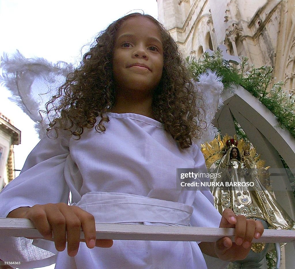 A child dressed as an angel is accompanied by an i