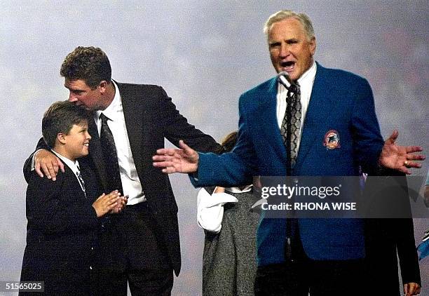 Miami Dolphins former head coach Don Shula speaks about former Dolphins quarterback Dan Marino as Marino kisses his son Joseph during a ceremony to...