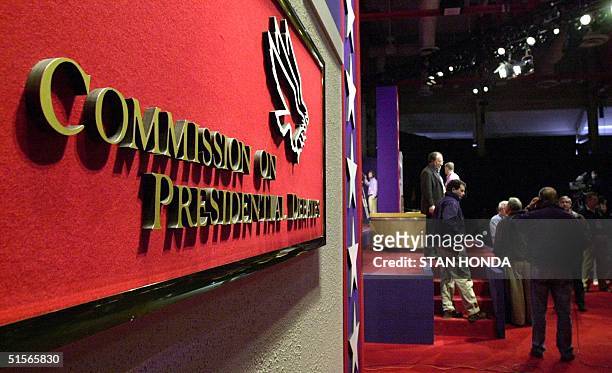 The Commission of Presidential Debate sign is seen in the foreground as workers prepare the stage at the University of Massachusetts in Boston 02...
