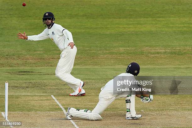 Ryan Carters of the Blues bats as Rob Quiney of the Bushrangers fields during day one of the Sheffield Shield match between Victoria and New South...