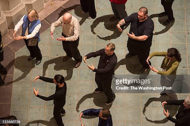 People participate in a Tai Chi exercise led by Nick Gracenina during a week of Seeing Deeper at the Washington National Cathedral during a week of...