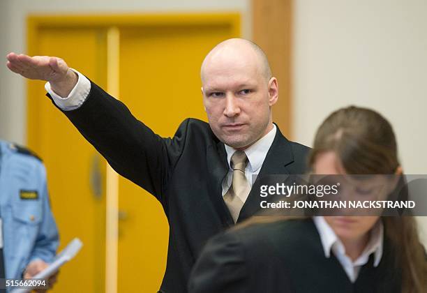 Norwegian mass killer Anders Behring Breivik makes a Nazi salute as he arrives to a makeshift court in Skien prisons gym on March 15, 2016 in Skien,...