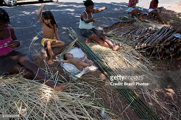 Black women make tapiti at Sao Raimundo Quilombo in Alcantara, Maranhao State, Northeastern Brazil - tapiti is a a long, tube-shaped basket of woven...