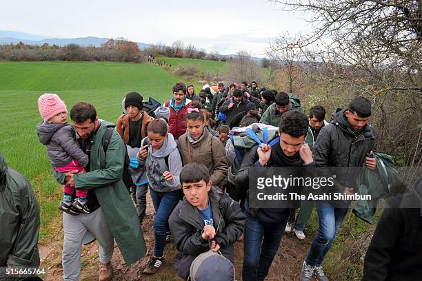Migrants trek towards Macedonia after leaving the Idomeni refugee camp on March 14, 2016 in Idomeni, Greece. The decision by Macedonia to close its...