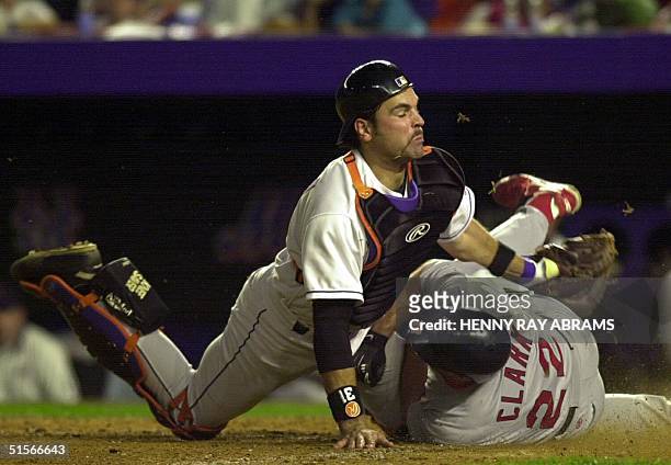 St. Louis Cardinals Will Clark slides into New york Mets Mike Piazza in the sixth ninning for an out during game three of the National League...