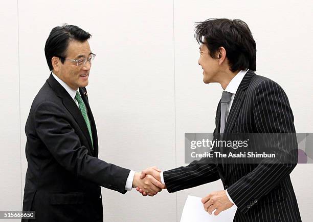 Democratic Party of Japan President Katsuya Okada and Japan Innovation Party leader Yorihisa Matsuno shake hands after announcing the selection of...