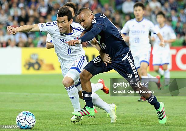 Cho Won Hee of Suwon and Archie Thompson of the Victory compete for the ball during the AFC Champions League match between the Melbourne Victory and...