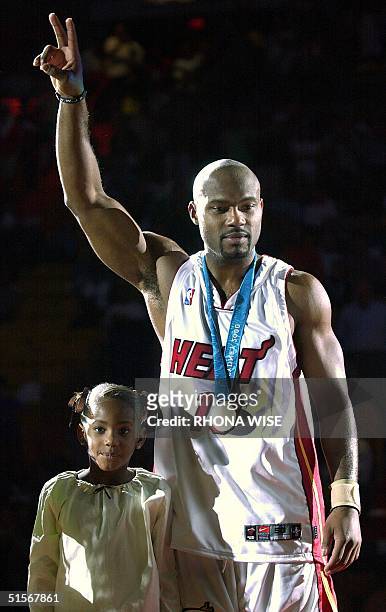 Miami Heat guard Tim Hardaway stands and waves to the crowd with his daughter Tia as he and teammate center Alonzo Mourning were honored by the Heat...