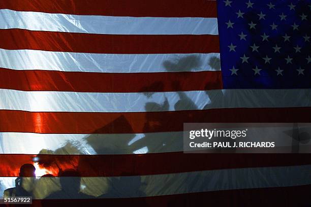 Flag has the shadows of supporters for Republican Presidential candidate Texas Governor George W. Bush cast up it during a late 02 November 2000 Bush...