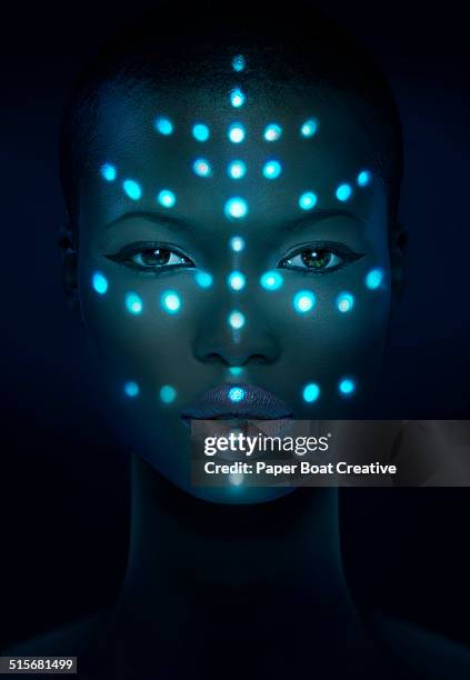 glowing laser beam dots on a woman's face - facial recognition technology stock-fotos und bilder