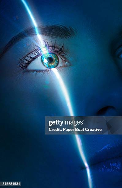 laser beam passing through the eye of a lady - laserlicht stock-fotos und bilder