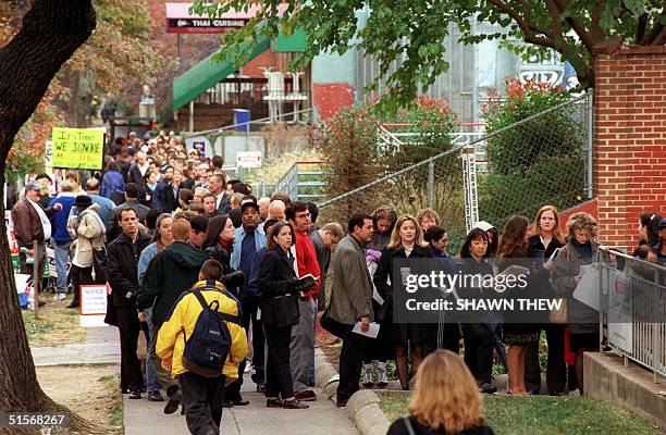 Voters wait in line outside the Foundry United Methodist Church in Washington, DC to cast their vote in the US presidential election 07 November,...