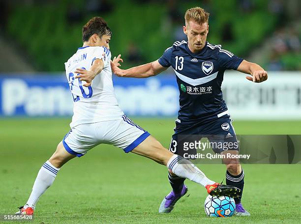 Oliver Bozanic of the Victory is tackled by Baek Jihoon of Suwon during the AFC Champions League match between the Melbourne Victory and Suwon...