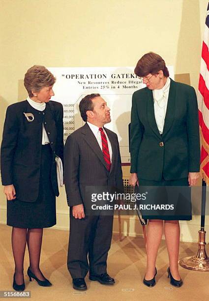 Attorney General Janet Reno talks with Labor Secretary Robert Reich as Doris Meissner , Commissioner of the Immigration and Naturalization Service...