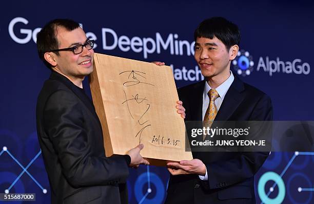 Lee Se-Dol , one of the greatest modern players of the ancient board game Go, presents the 'Go' game board with his signature to Google Deepmind head...