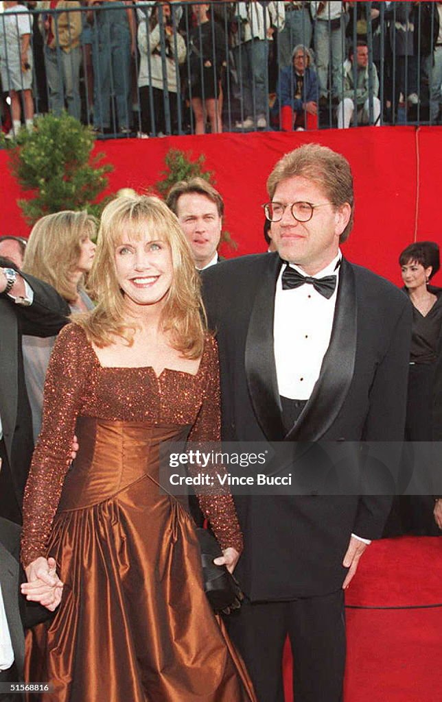 Director Robert Zemeckis (R) arrives with his wife