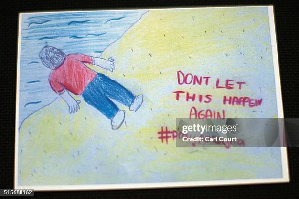 Postcard depicting Aylan Kurdi, a young Syrian boy who lost his life attempting to cross the Mediterranean from Turkey to Greece, is displayed at the...