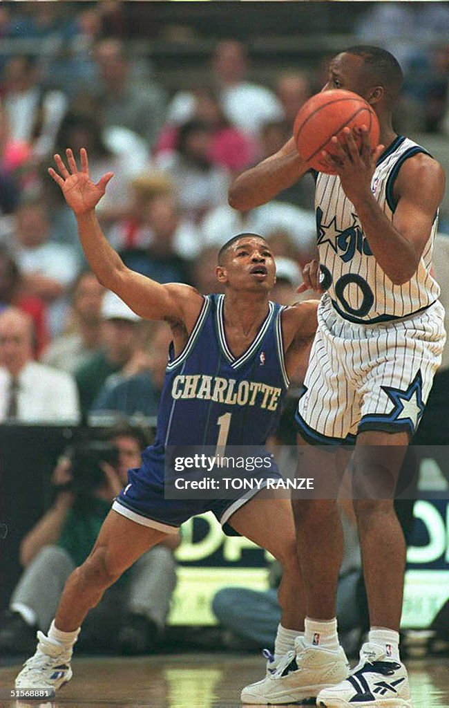 Orlando Magic guard Brian Shaw (R) makes a pass ov