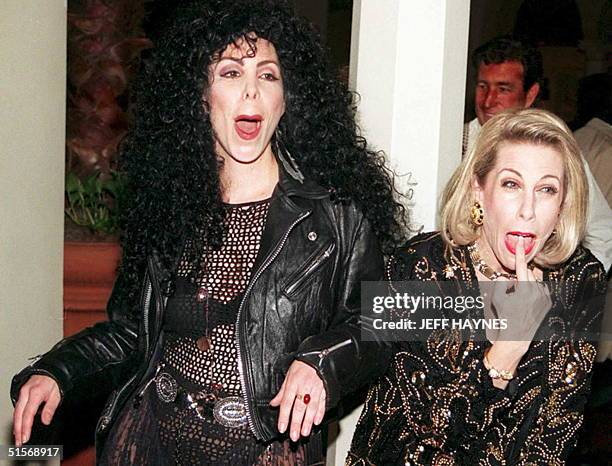 Lissa Negrin , dressed like US entertainer Cher, and Dee Dee Hanson, dressed like US comedienne Joan Rivers, pose for photographers 20 March as they...