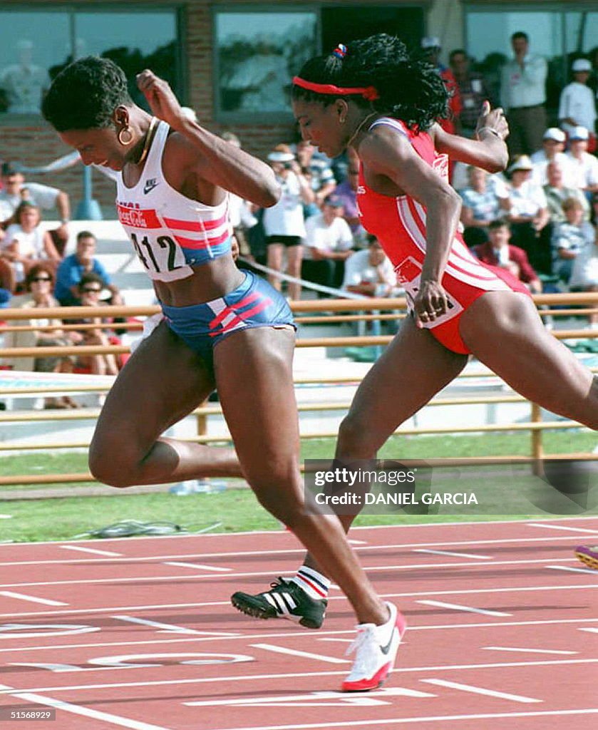 Chryste Gaines of the US leans to cross the finish line first in the