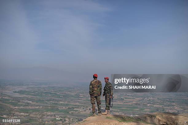 Afghan National Army soldiers keep watch in Dand-e-Ghori district in Baghlan province on March 15 following weeks of heavy battles to recapture the...