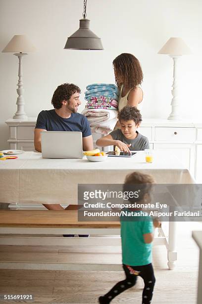 family relaxing in dining room - washing curly hair stock pictures, royalty-free photos & images