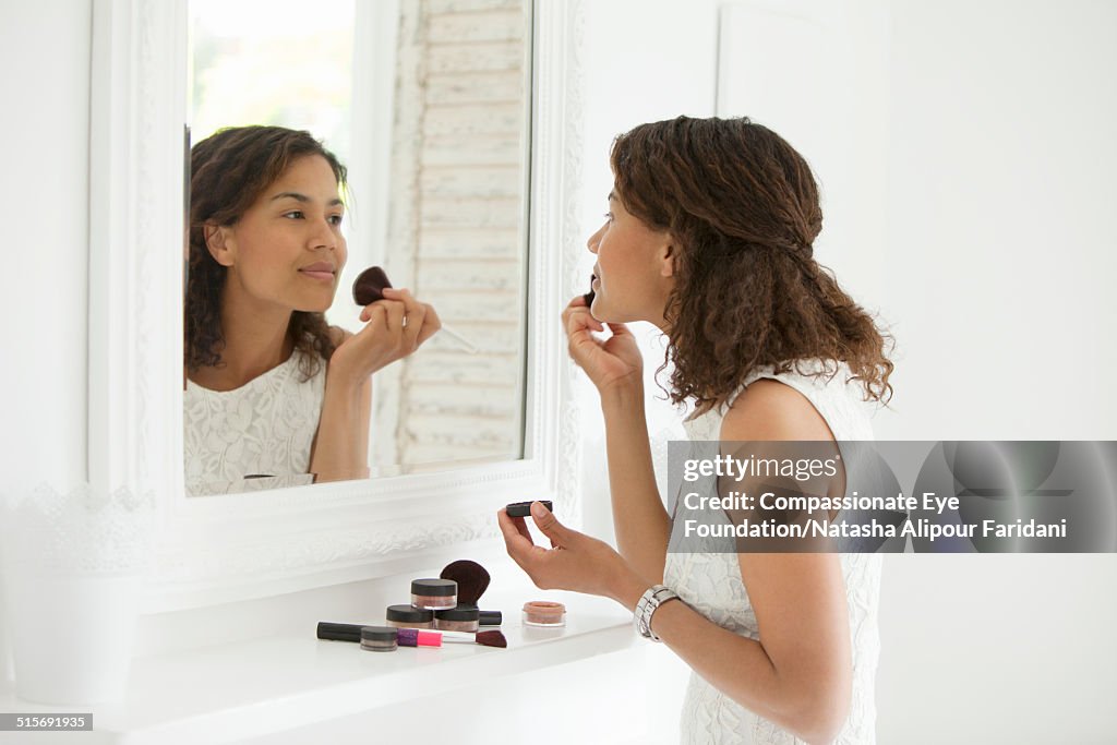 Woman applying makeup with brush