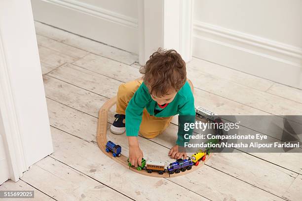 toddler playing with toy train set - toy train set stock pictures, royalty-free photos & images