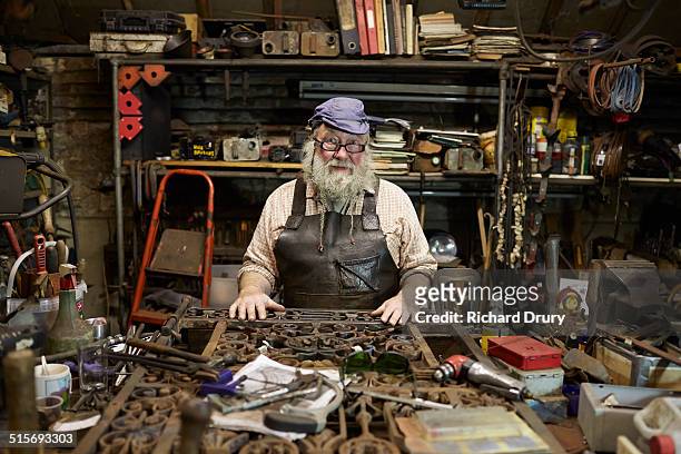 Blacksmith in his forge with metal gate