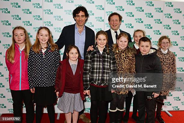 Stephen Mangan and Ed Vaizey MP pose with children at the 2016 Into Film Awards at Odeon Leicester Square on March 15, 2016 in London, England.