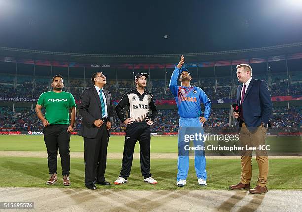 Dhoni, Captain of India tosses the coin with Kane Williamson, Captain of New Zealand during the ICC World Twenty20 India 2016 Group 2 match between...