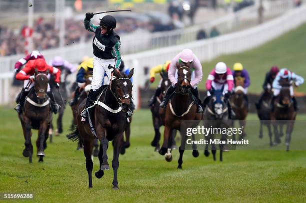 Nico de Boinville celebrates after riding Altior to victory in the Sky Bet Supreme Novices' Hurdle Race on day one, Champion Day, of the Cheltenham...