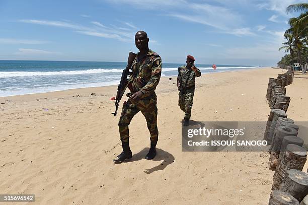 Soldiers patrol the beach in Grand-Bassam on March 15 a day after gunmen attacked the Ivory Coast resort town popular with Ivorians and Westerners,...