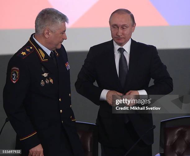 Russian President Vladimir Putin and Interior Minister Vladimir Kolokoltsev attend the extended board of Russian Interior Ministry on March 15, 2016...