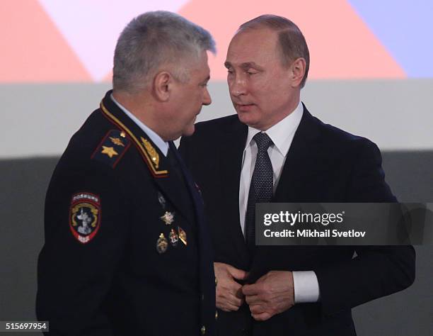 Russian President Vladimir Putin and Interior Minister Vladimir Kolokoltsev attend the extended board of Russian Interior Ministry on March 15, 2016...