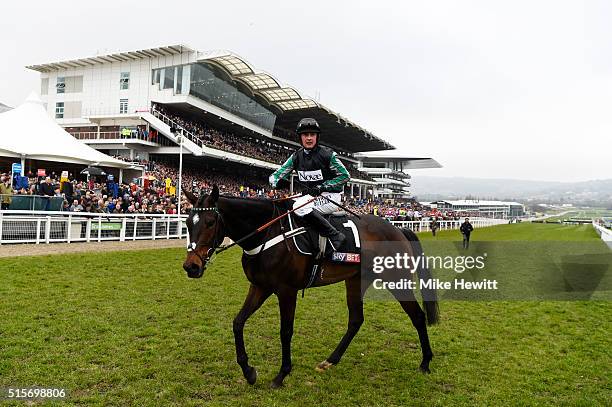 Nico de Boinville celebrates after riding Altior to victory in the Sky Bet Supreme Novices' Hurdle Race on day one, Champion Day, of the Cheltenham...