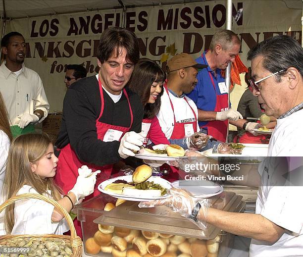 Actor Tony Danza and daughter Emily prepare traditional Thanksgiving Day dinners to be served by volunteers to over 5,000 homeless people at the Los...