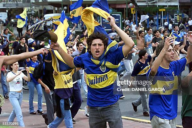 Fans of the Argentine soccer team Boca Juniors celebrate 28 November 2000 in central Buenos Aires the team's victory in the final of the...